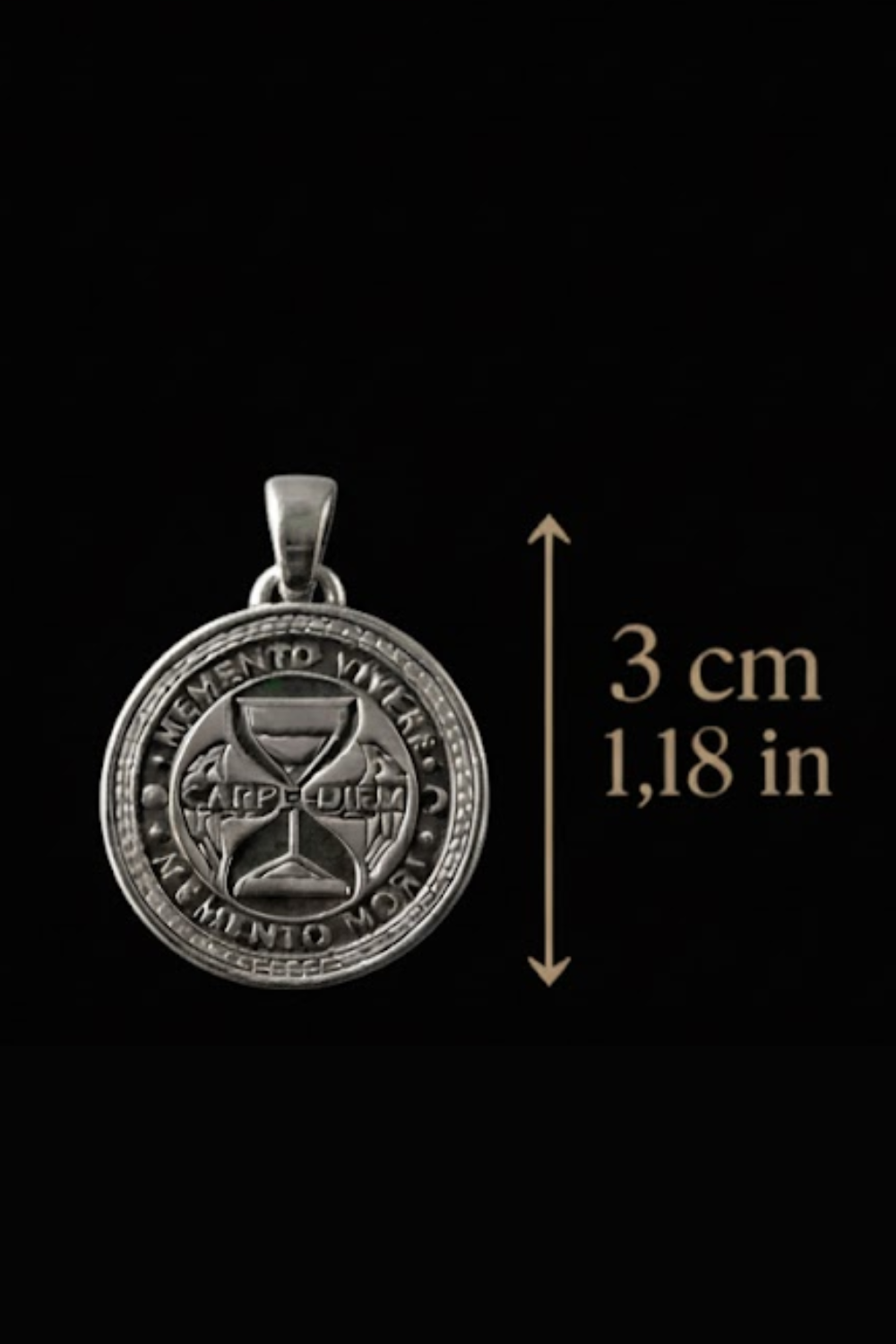 a silver pendant with a circular design, possibly a medallion or charm, and a measurement scale indicating its size.