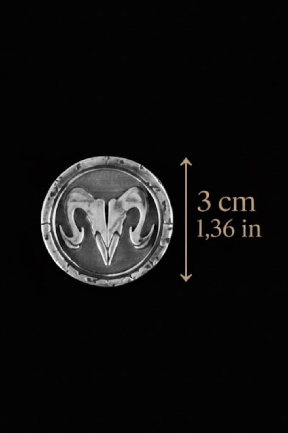 a silver-colored emblem with a ram's head design, and it is approximately 3 centimeters in diameter.