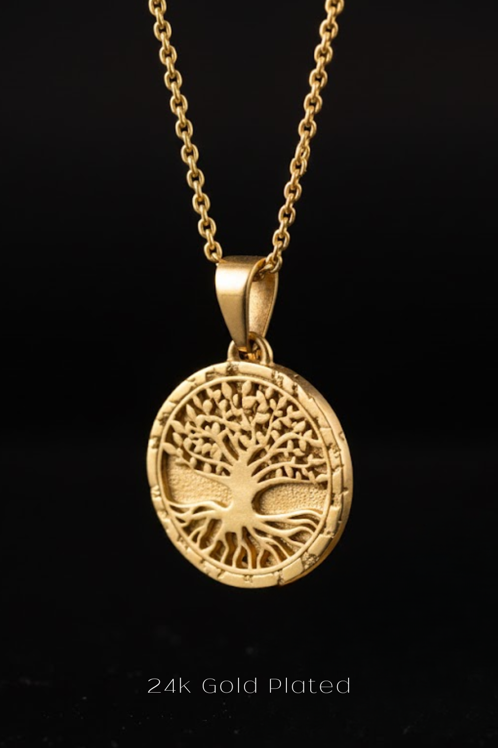 A gold-plated pendant necklace with a circular medallion featuring a tree design.