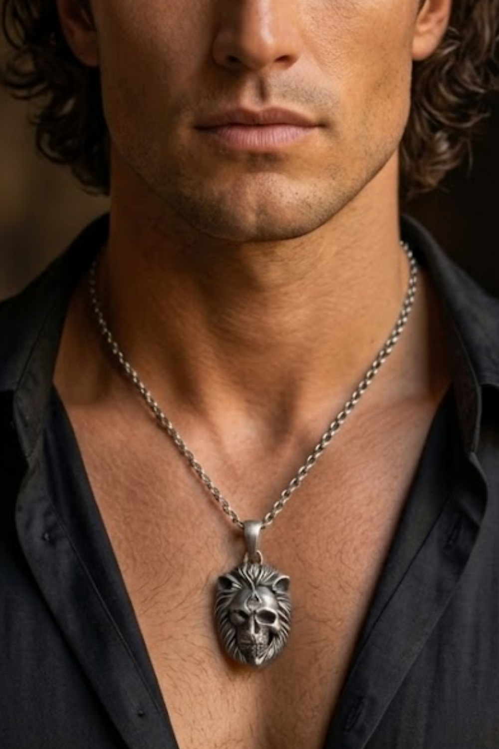 A close-up of a man's neck and chest area, with a silver pendant necklace featuring a lion's head pendant.