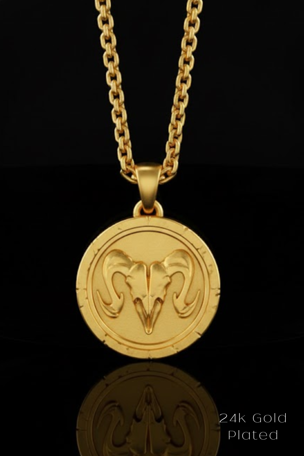A gold-colored pendant necklace with a circular medallion featuring a ram's head design.