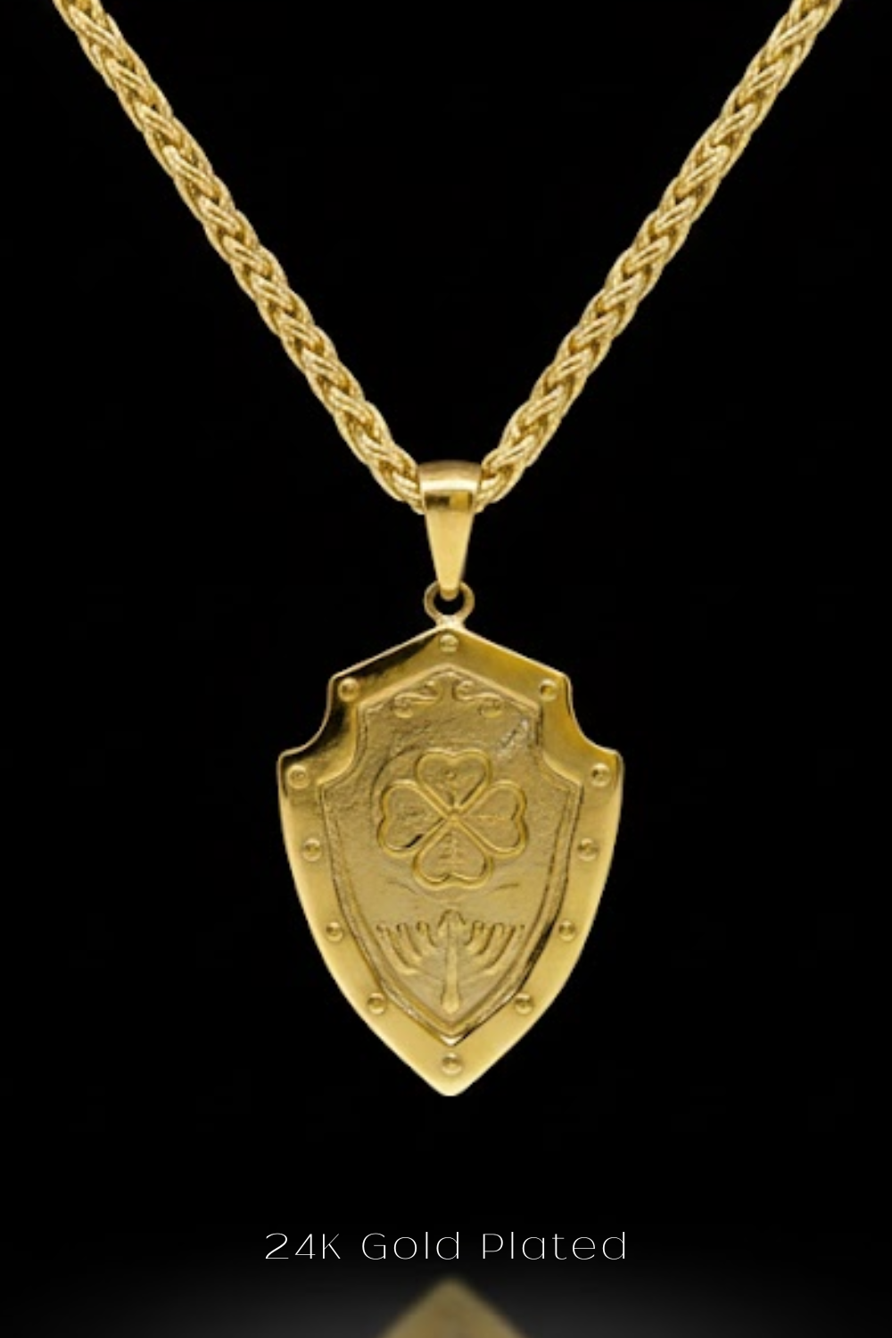 A 24K gold-plated pendant necklace with a shield-shaped pendant featuring a four-leaf clover design.