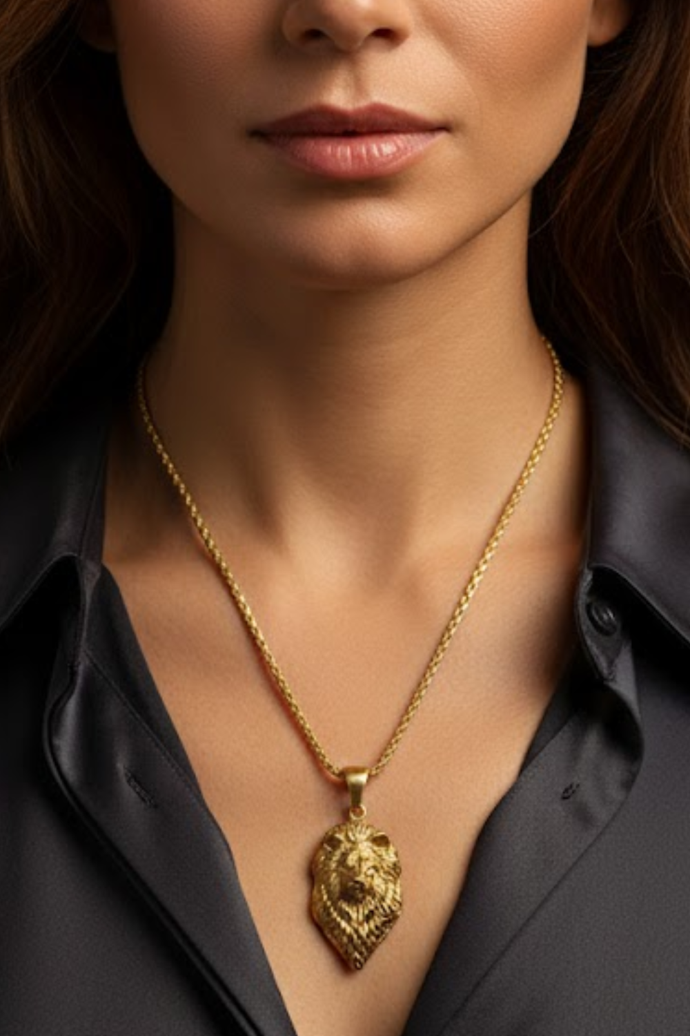 A close-up of a woman wearing a gold necklace with a pendant.