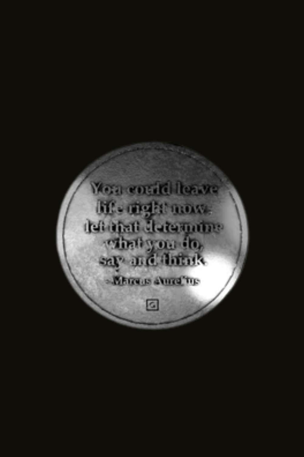 a quote in a circular format, which is a black and white photograph with a reflective surface.