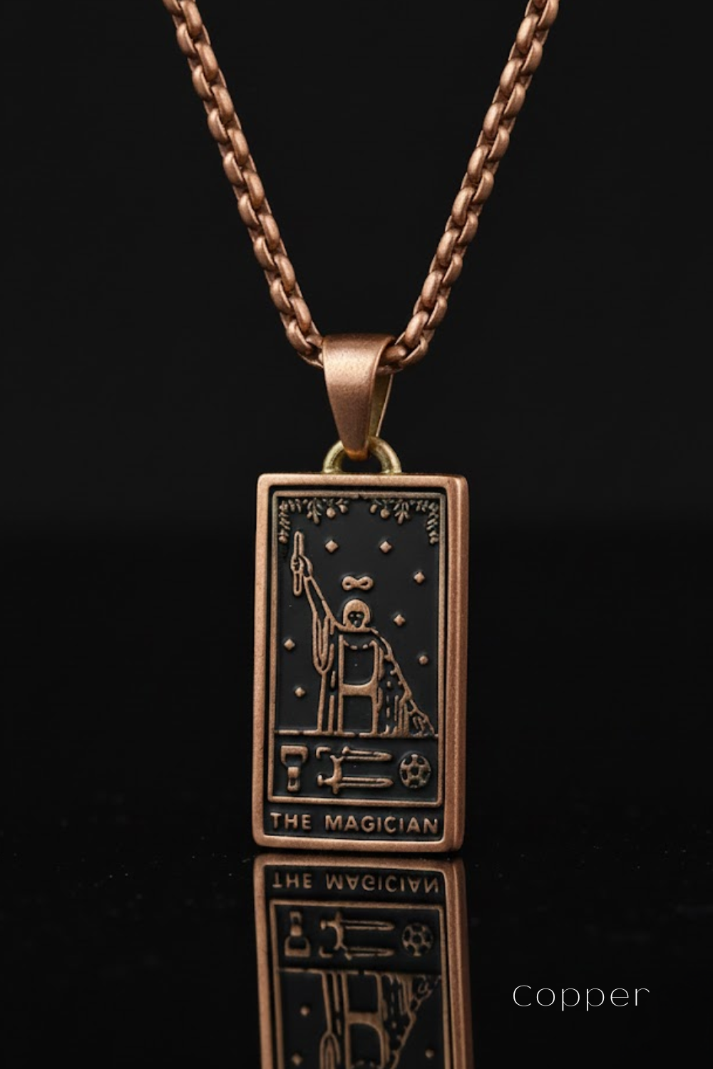 A copper-colored pendant necklace with a rectangular pendant featuring an illustration of a tarot card, specifically "The Magician".