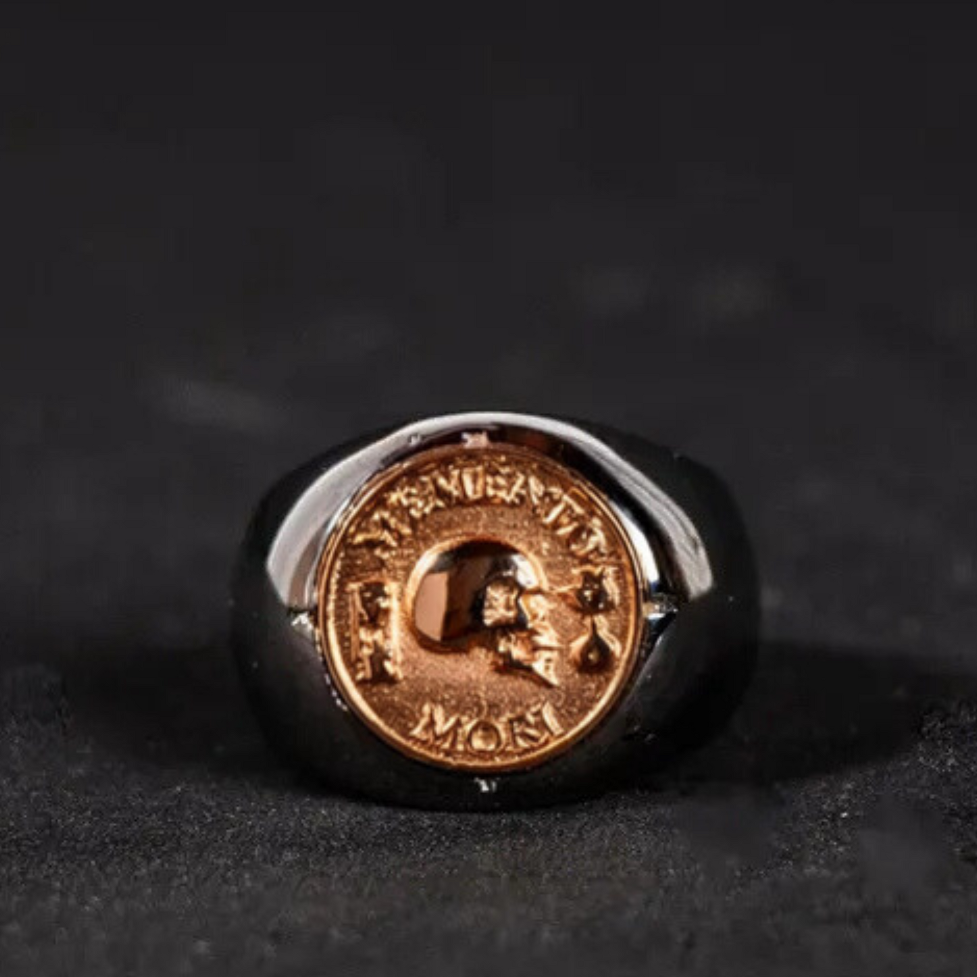 A ring with a gold-colored emblem featuring a skull and crossbones design.