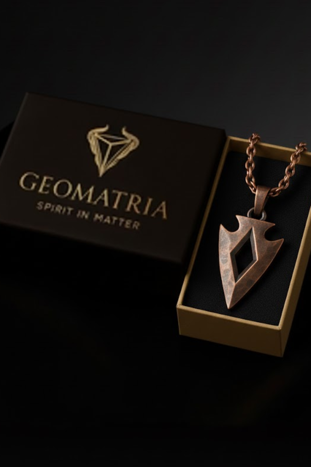 A necklace with a pendant is displayed in a box with the text "Geomatria Spirit in Matter" printed on it.