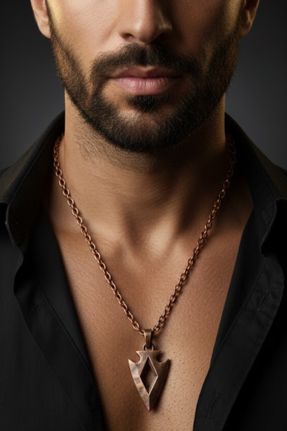 A close-up of a man's neck and chest area, with a necklace featuring a pendant hanging from his neck.