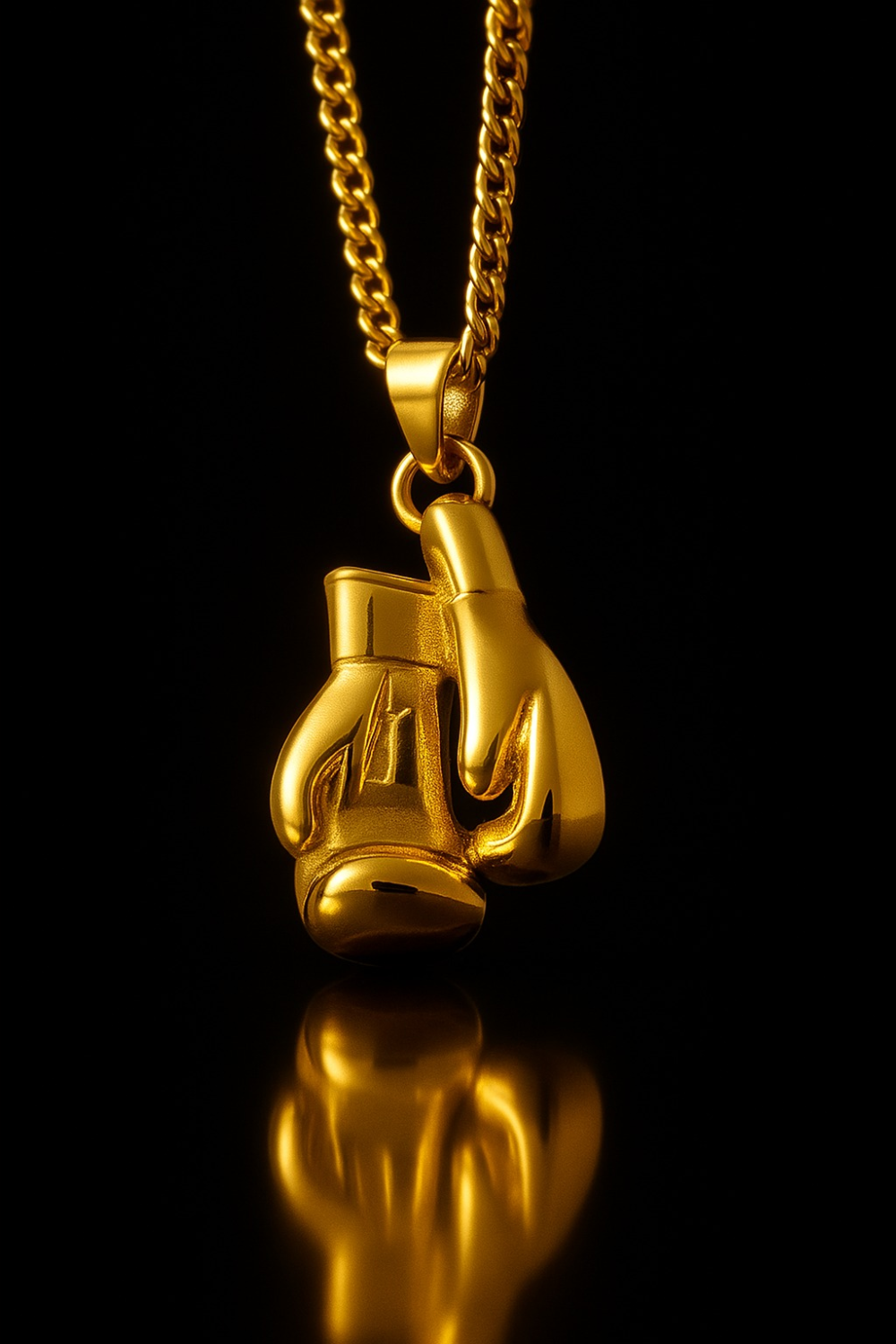 A gold-colored pendant necklace with a pair of golden boxing gloves hanging from it against a black background.
