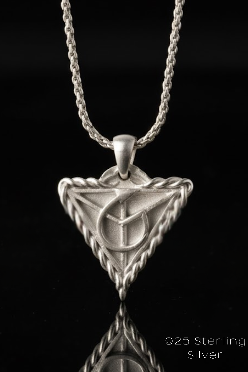A silver-colored pendant necklace with a triangular pendant featuring a symbol or design.