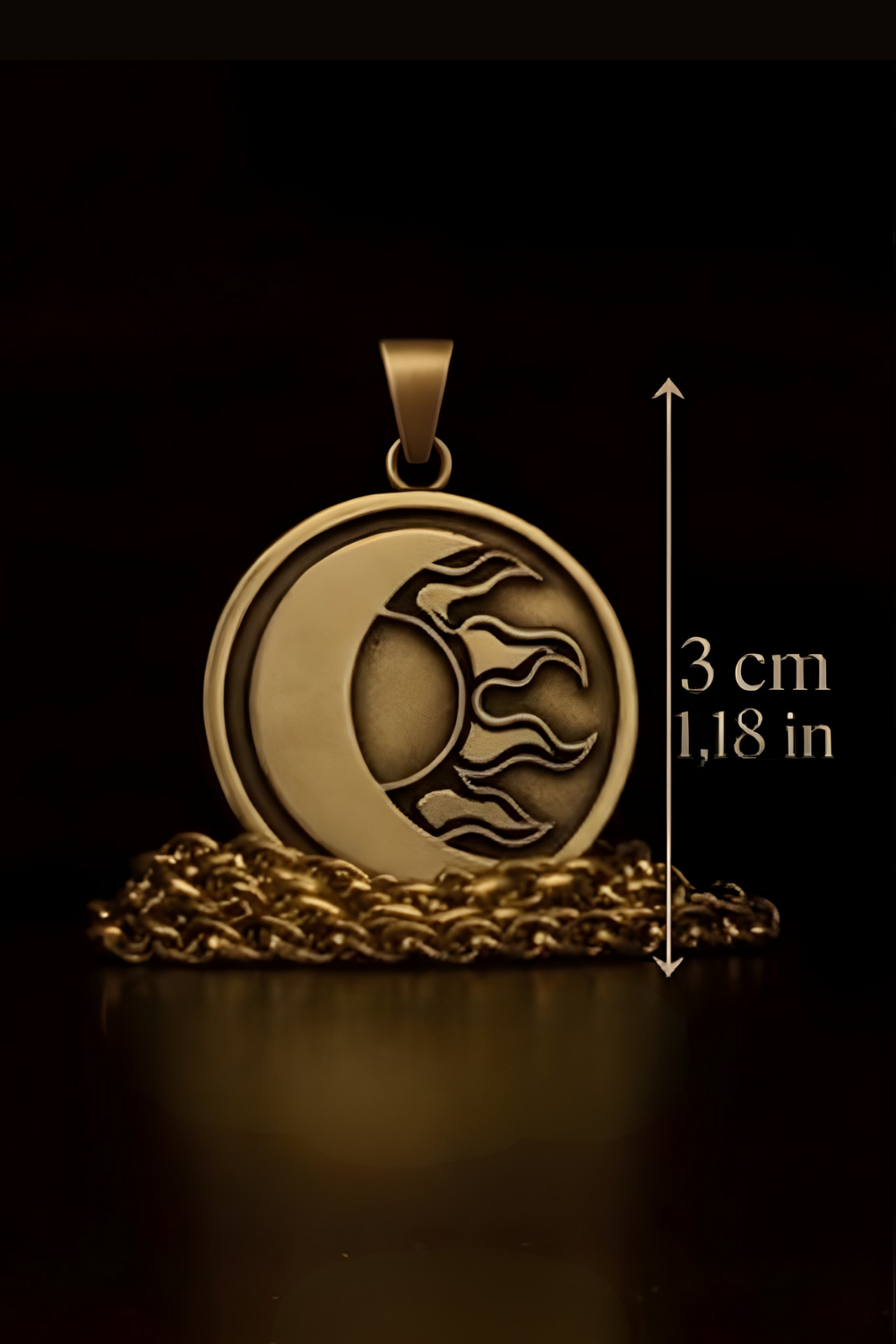 A pendant in the shape of a crescent moon with a sun design, resting on a chain against a dark background.